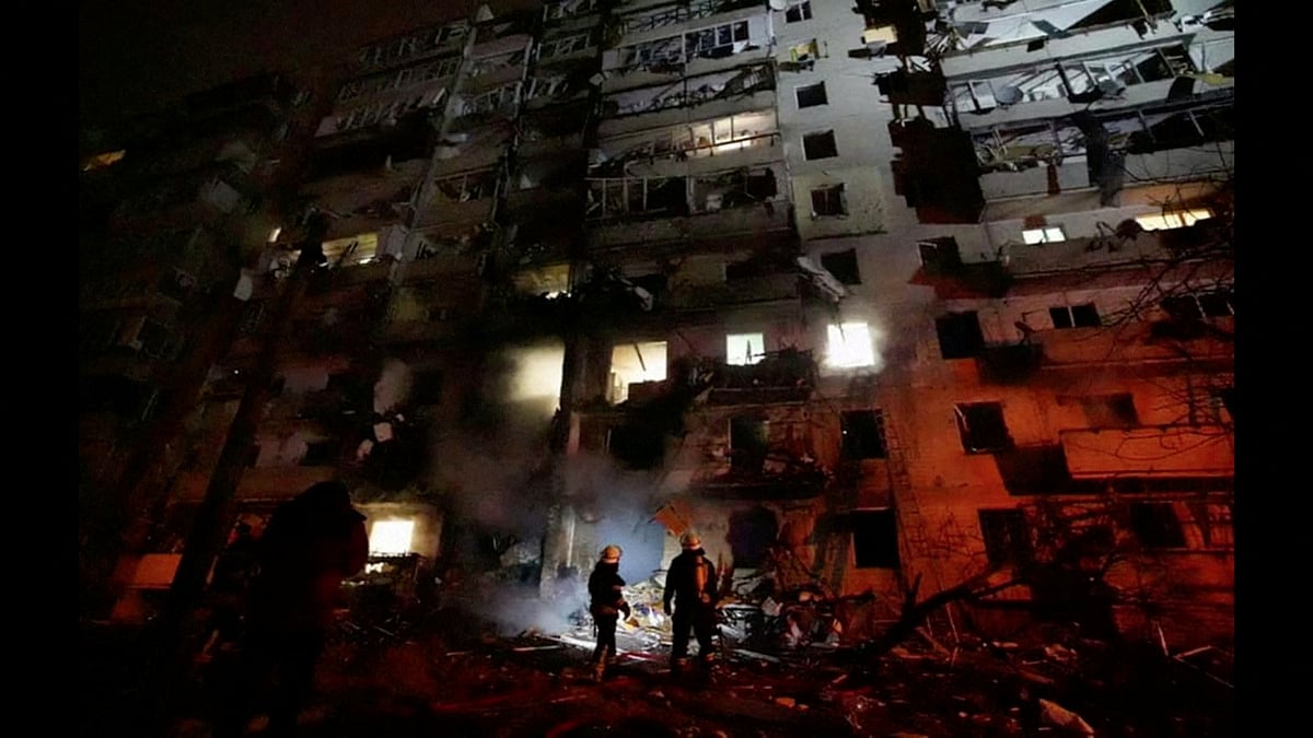 Firefighters work at the site of a damaged residential building, after Russia launched a massive military operation against Ukraine, in Kyiv, Ukraine, on 25 February 2022 in this frame grab of a still image use in a video