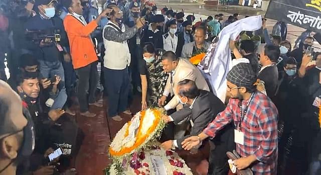 People flock to the central Shaheed Minar with flowers in their hands