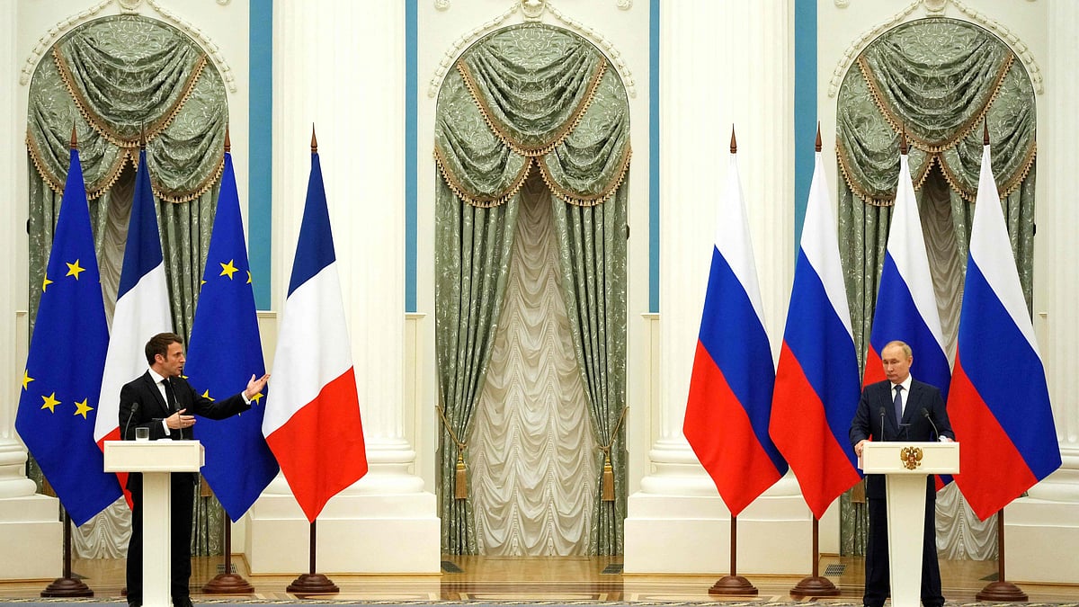 Russian President Vladimir Putin (R) listens during a joint press conference with French President Emmanuel Macron in Moscow, on 7 February 2022.