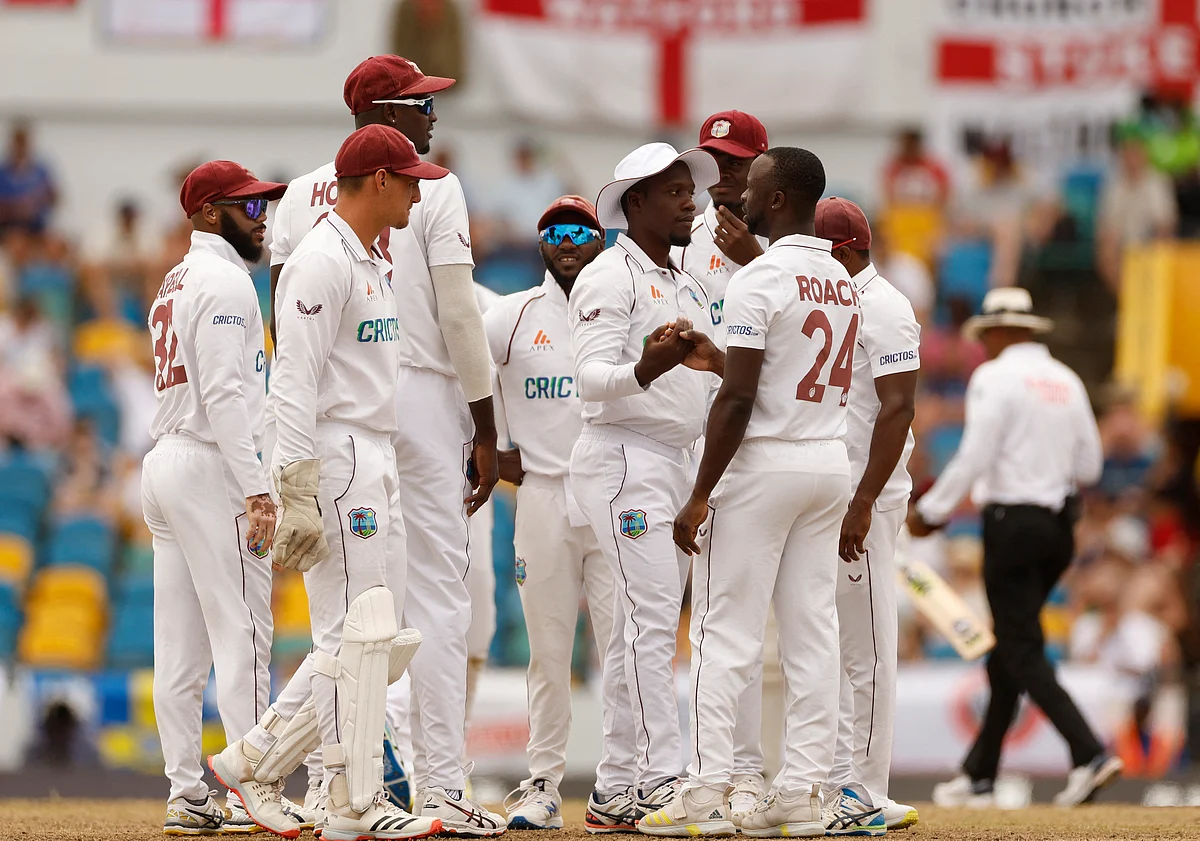West Indies' Kemar Roach celebrates with teammates after taking the wicket of England's Ben Stokes