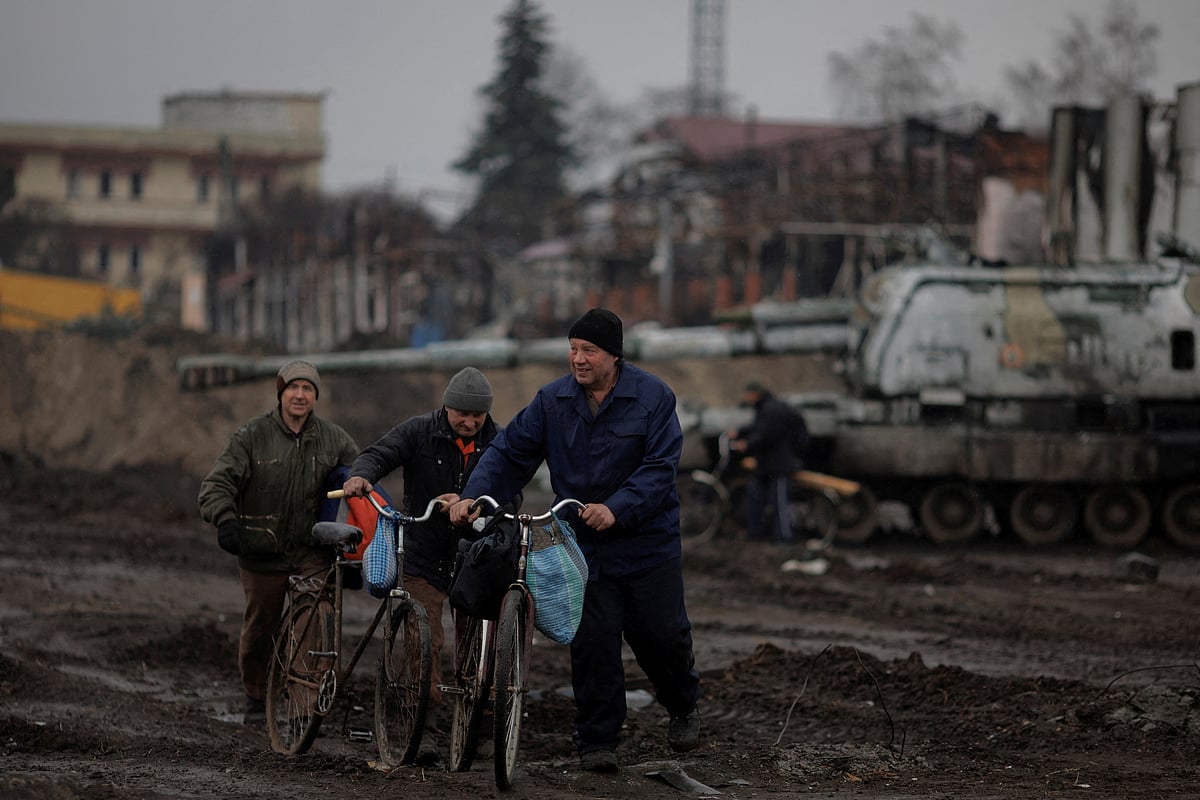 Locals walk in the demolished town center of Trostyanets after Ukrainian forces expelled Russian troops from the town which Russia had occupied at the beginning of its war with Ukraine, on 30 March, 2022