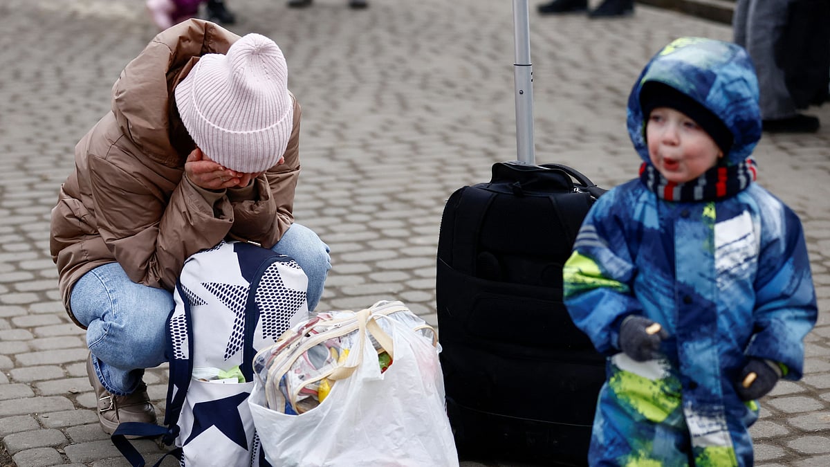 A man hugs his family after fleeing the Russian invasion of Ukraine, at the border checkpoint in Medyka, Poland, 4 March 2022.