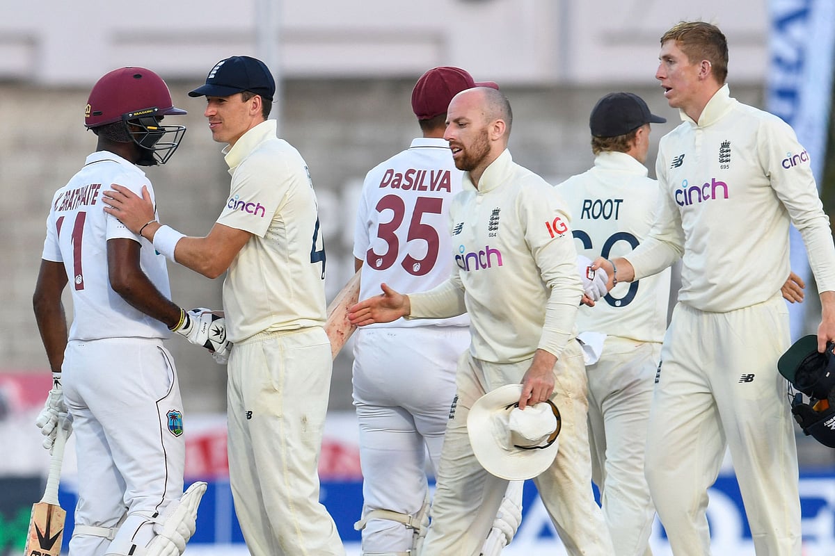 Matthew Fisher (2L) and Jack Leach (2R) of England congratulate Kraigg Brathwaite (L)of West Indies at the end of the 5th and final day of the 2nd Test between West Indies and England at Kensington Oval, Bridgetown, Barbados, on 20 March, 2022