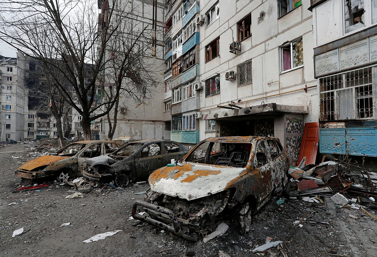 Destroyed cars are seen in front of an apartment building which was damaged during Ukraine-Russia conflict in the besieged southern port city of Mariupol, Ukraine on 27 March, 2022