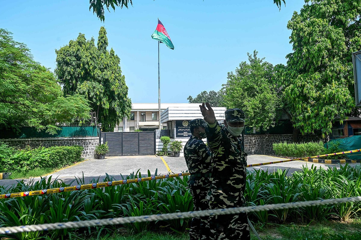 In this file photo taken on 17 August, 2021, security personnel stand guard outside the Afghan embassy in New Delhi.