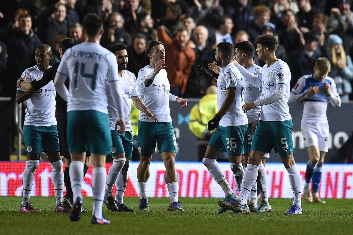 Manchester City's Algerian midfielder Riyad Mahrez (3rd R) celebrates with teammates after scoring a goal during the English FA cup fifth round football match between Peterborough United and Manchester City at the Weston Homes Stadium, in Peterborough, on 1 March, 2022