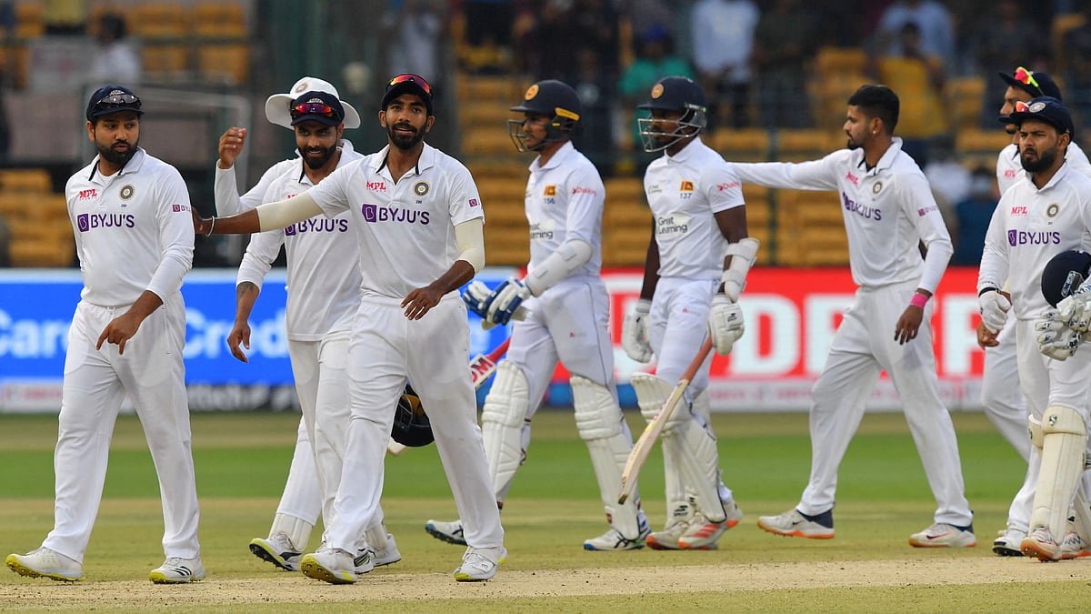 India's players celebrate their win as they walk back to the pavilion at the end of the second Test cricket match between India and Sri Lanka at the M. Chinnaswamy Stadium in Bangalore on 14 March, 2022