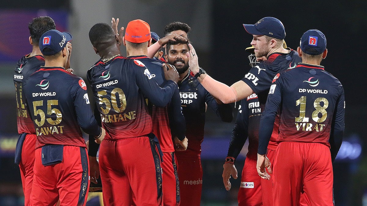 Royal Challengers Bangalore's Wanindu Hasaranga celebrates with teammates after taking a wicket during the IPL match against Kolkata Knight Riders on 30 March, 2022