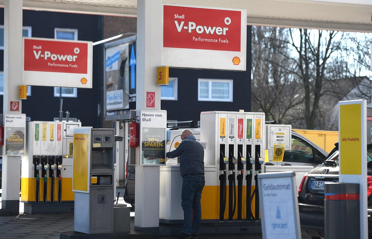 A photograph taken on 8 March 2022 shows a man standing at a Jet petrol station, in Essen, western Germany