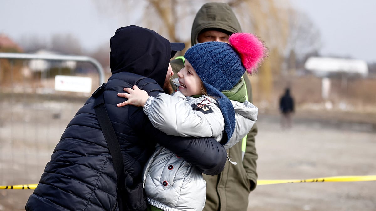 A father hugs her daughter after she fled the Russian invasion of Ukraine, at the border checkpoint in Medyka, Poland, 4 March 2022.