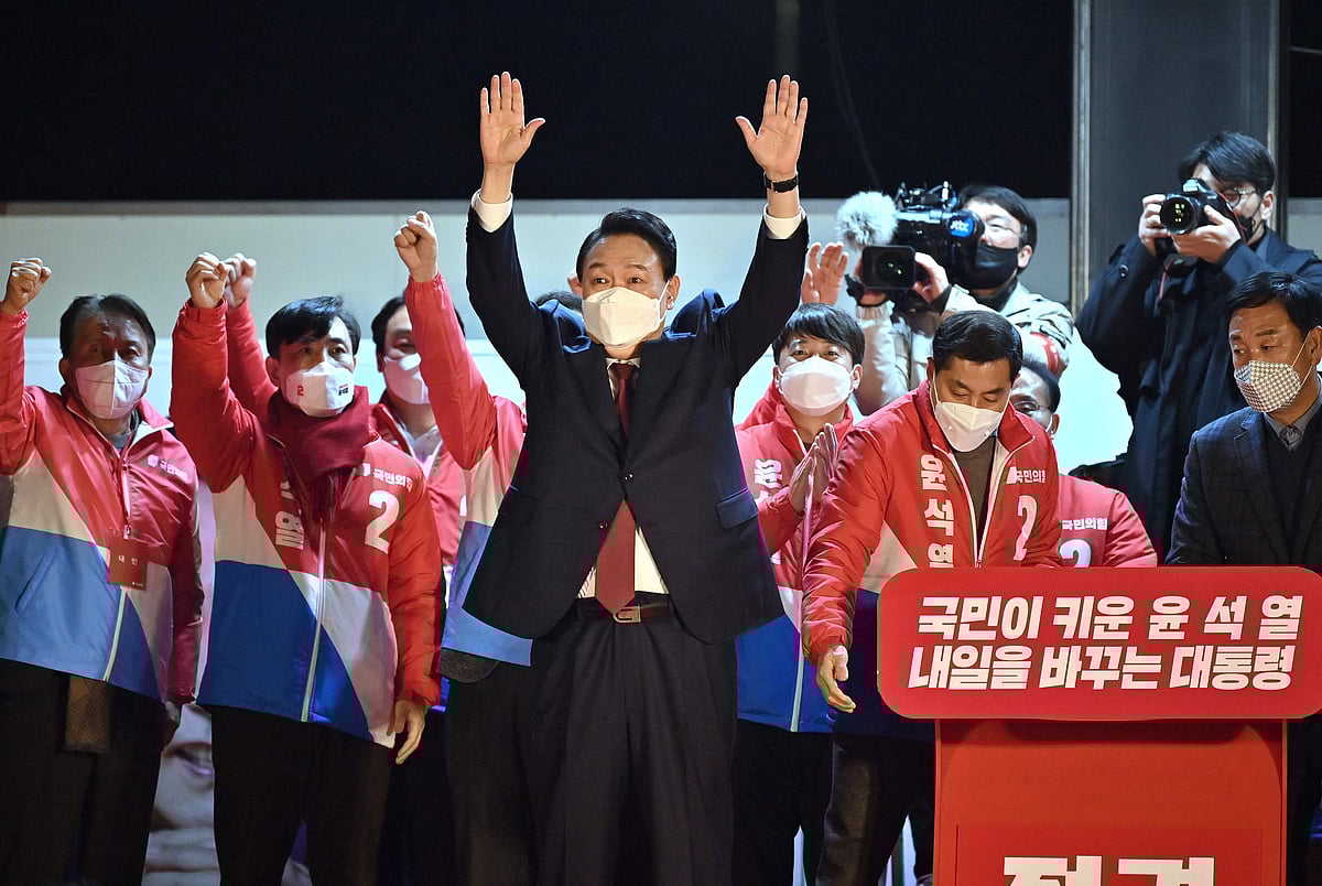 South Korea's new president-elect Yoon Suk Yeol (C), of the main opposition People Power Party, gestures to his supporters as he is congratulated outside the party headquarters in Seoul, South Korea, on 10 March, 2022