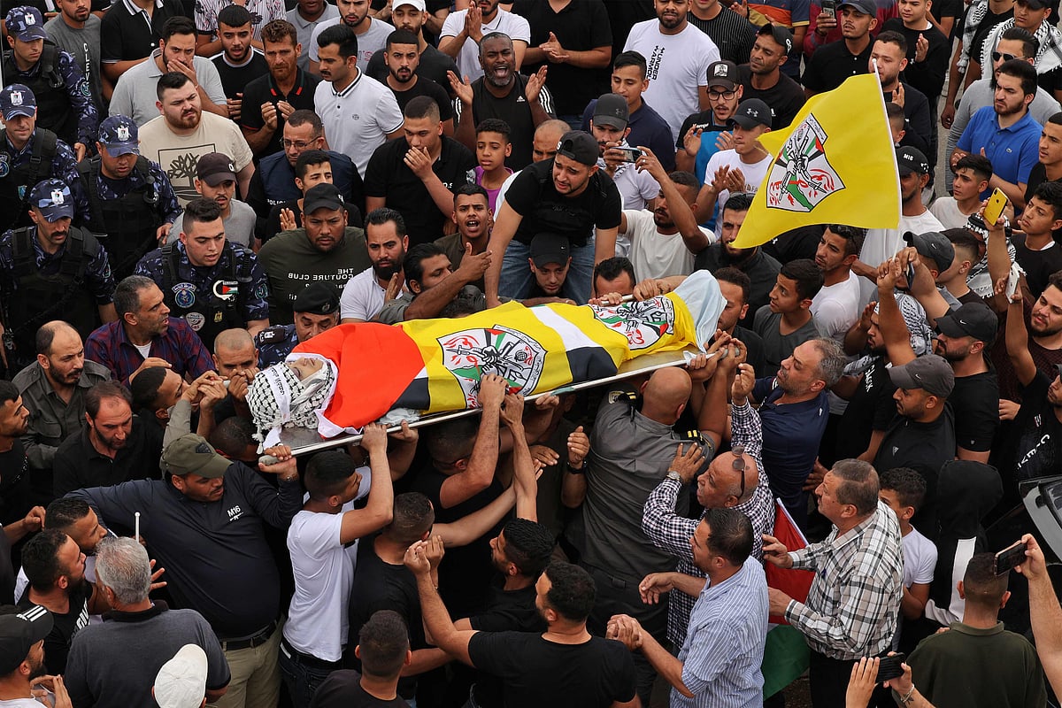 Palestinians carry the body of Ahmed Ibrahim Oweidat, who was killed during an Israeli forces operation, during his funeral in Jericho in the Israeli-occupied West Bank, on 26 April, 2022