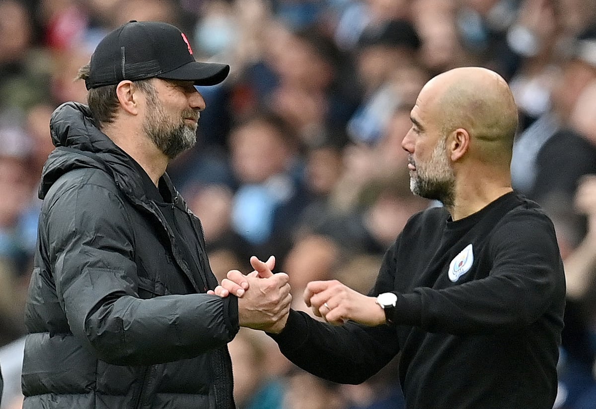 Liverpool's German manager Jurgen Klopp (L) shakes hands with Manchester City's Spanish manager Pep Guardiola