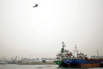 A Lebanese Armed Forces helicopter hovers above the port of Tripoli, a day after a boat of around 60 migrants capsized off the coast of the northern city, on 24 April 2022.