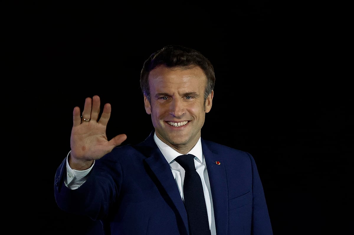 French President Emmanuel Macron waves at the stage, after being re-elected as president, following the results in the second round of the 2022 French presidential election, during his victory rally at the Champ de Mars in Paris, France on 24 April, 2022