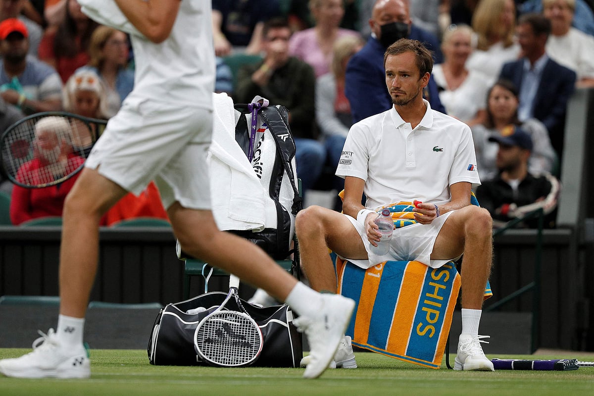 In this file photo taken on 6 July, 2021 Russia's Daniil Medvedev (R) reacts during a break in play against Poland's Hubert Hurkacz in their men's singles fourth round match on the eighth day of the 2021 Wimbledon Championships