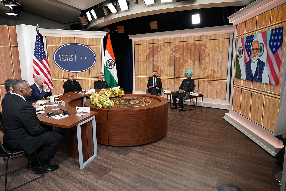 US President Joe Biden (C), alongside US Secretary of Defense Lloyd Austin (L) and India's Minister of Defense Rajnath Singh (3L), takes part in a virtual meeting with India's Prime Minister Narendra Modi in the South Court Auditorium of the Eisenhower Executive Office Building, next to the White House, in Washington, DC on 11 April, 2022