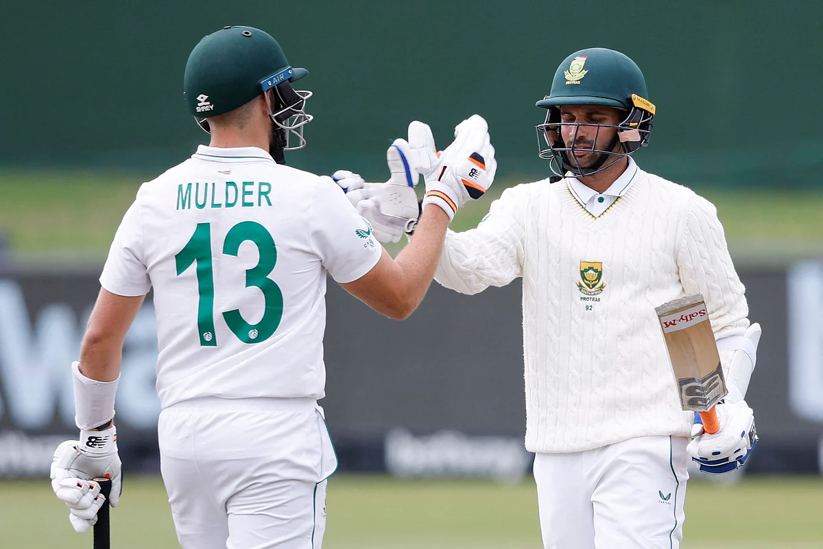 South Africa's Keshav Maharaj (R) is congratulated by Wiaan Mulder (L) after scoring a half-century during the second day of the second Test between South Africa and Bangladesh at St George's Park in Port Elizabeth on Saturday.