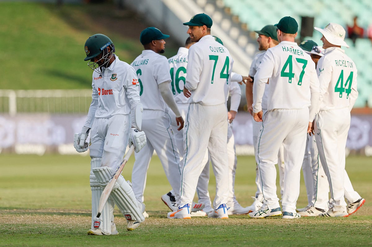 Bangladesh's Mahmudul Hasan Joy (L) walks back to the pavilion after his dismissal by South Africa's Keshav Maharaj (not seen) during the fourth day of the first Test between South Africa and Bangladesh at the Kingsmead stadium in Durban on Sunday.