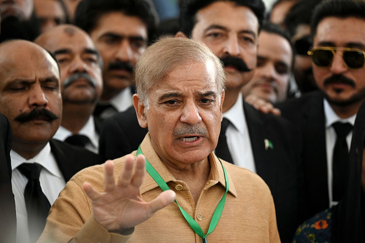 Pakistan's opposition leader Shehbaz Sharif (C) speaks with the media before attending a hearing outside the Supreme Court building in Islamabad on 7 April, 2022