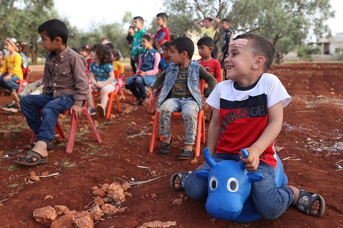 Volunteers from Syria's Violet Org charity's psychological support unit organise games during Eid al-Fitr celebrations for displaced children at a camp in the village of Killi in the Syrian rebel-held northwestern city of Idlib, on 3 May, 2022