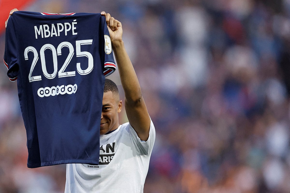 Paris St Germain's Kylian Mbappe holds up a shirt after signing a new contract at the Parc des Princes, Paris, France on 21 May, 2025