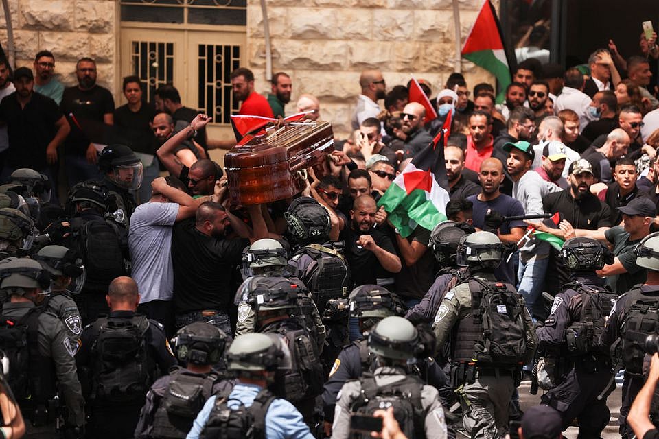 Family and friends carry the coffin of Al Jazeera reporter Shireen Abu Akleh as clashes erupted with Israeli security forces, during her funeral in Jerusalem