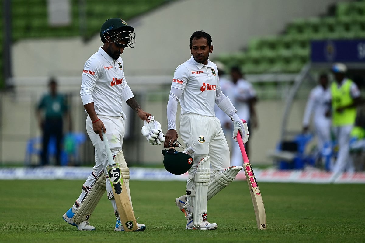 Mushfiqur Rahim (R) and Liton Das walk back to the pavilion at the end of the fourth day play of the second Test cricket match between Bangladesh and Sri Lanka