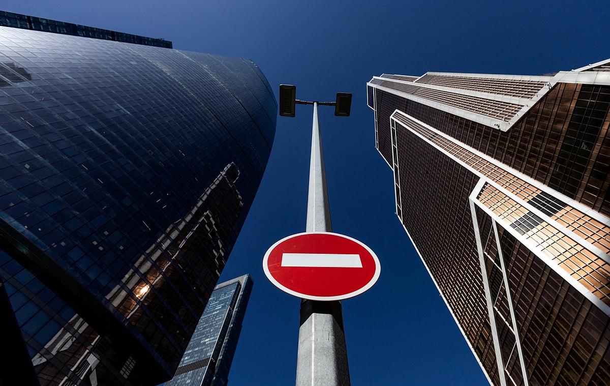 A stop road sign is seen next to skyscrapers at Moscow International business centre in Moscow, Russia.