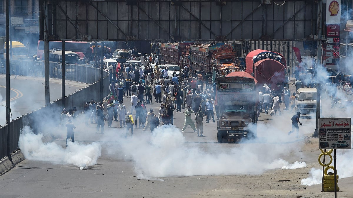 Police use tear gas to disperse activists of the Pakistan Tehreek-e-Insaf (PTI) party of ousted prime minister Imran Khan during a protest in Lahore on 25 May 2022, as all roads leading into Pakistan's capital were blocked ahead of a major protest planned by ousted prime minister Imran Khan and his supporters.