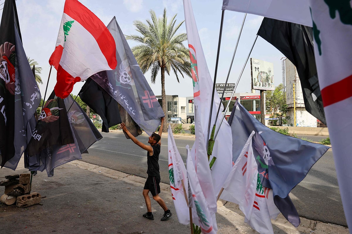 Flags of the Lebanese Forces political party sway in the wind outside a restaurant in the Lebanese coastal city of Byblos (Jbeil), north of the capital Beirut, on 15 May, 2022, as voters started casting their ballots in the parliamentary election