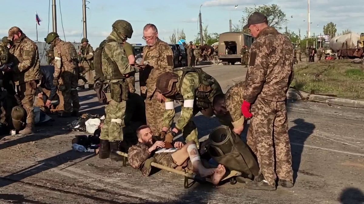 This screen grab obtained from a handout video released by the Russian Defence Ministry on 17 May, 2022, shows Ukrainian service members as they are searched by pro-Russian military personnel after leaving the besieged Azovstal steel plant in Ukraine's port city of Mariupol