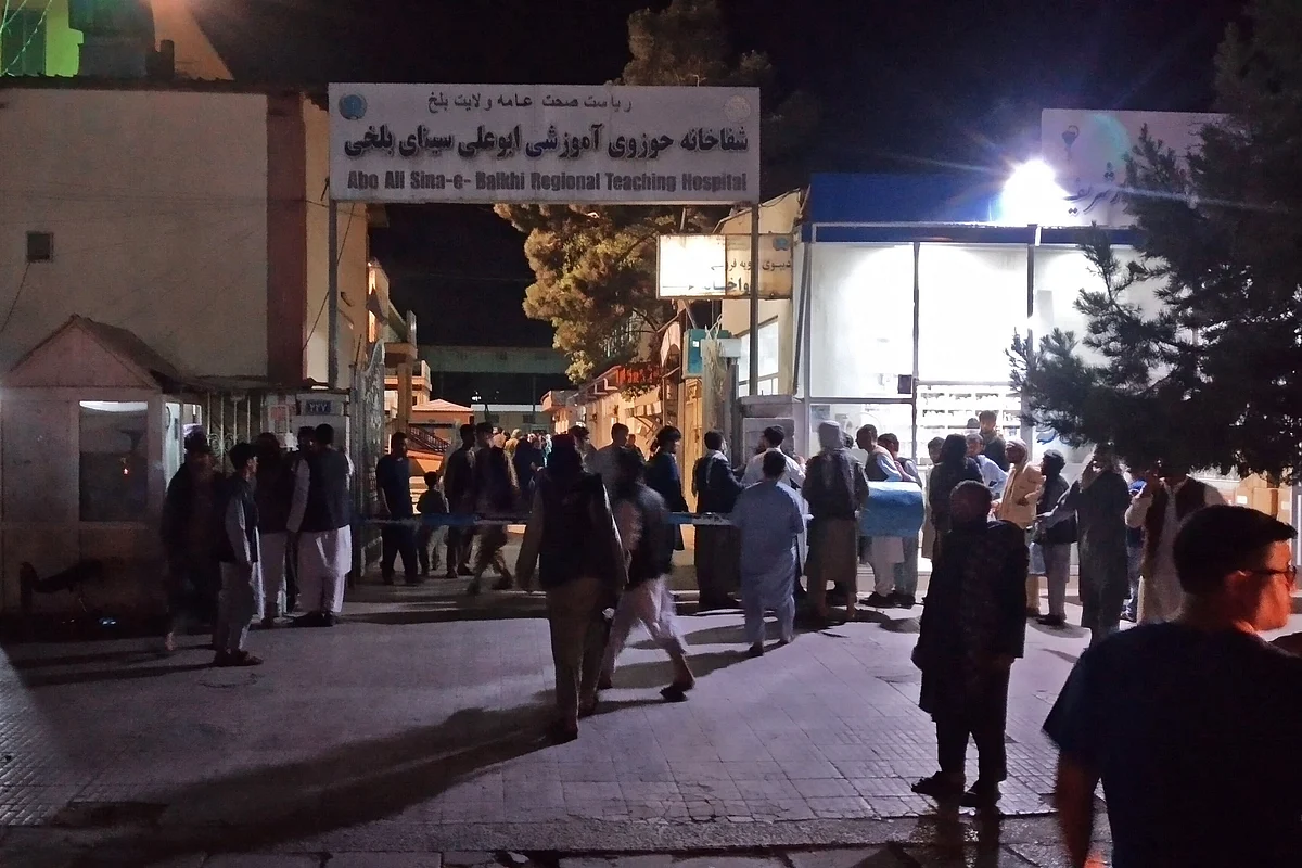 Relatives of bomb blasts victims gather outside a hospital in Mazar-i-Sharif on 25 May, 2022. Four bombs ripped through minibuses and a mosque in Afghanistan on 25 may , killing at least 11 people, officials said.