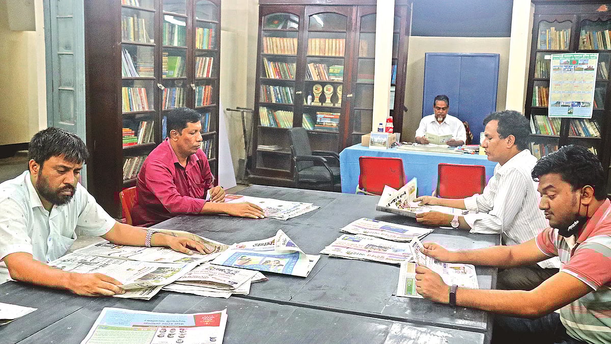 People reading newspapers at    Rangpur Public Library