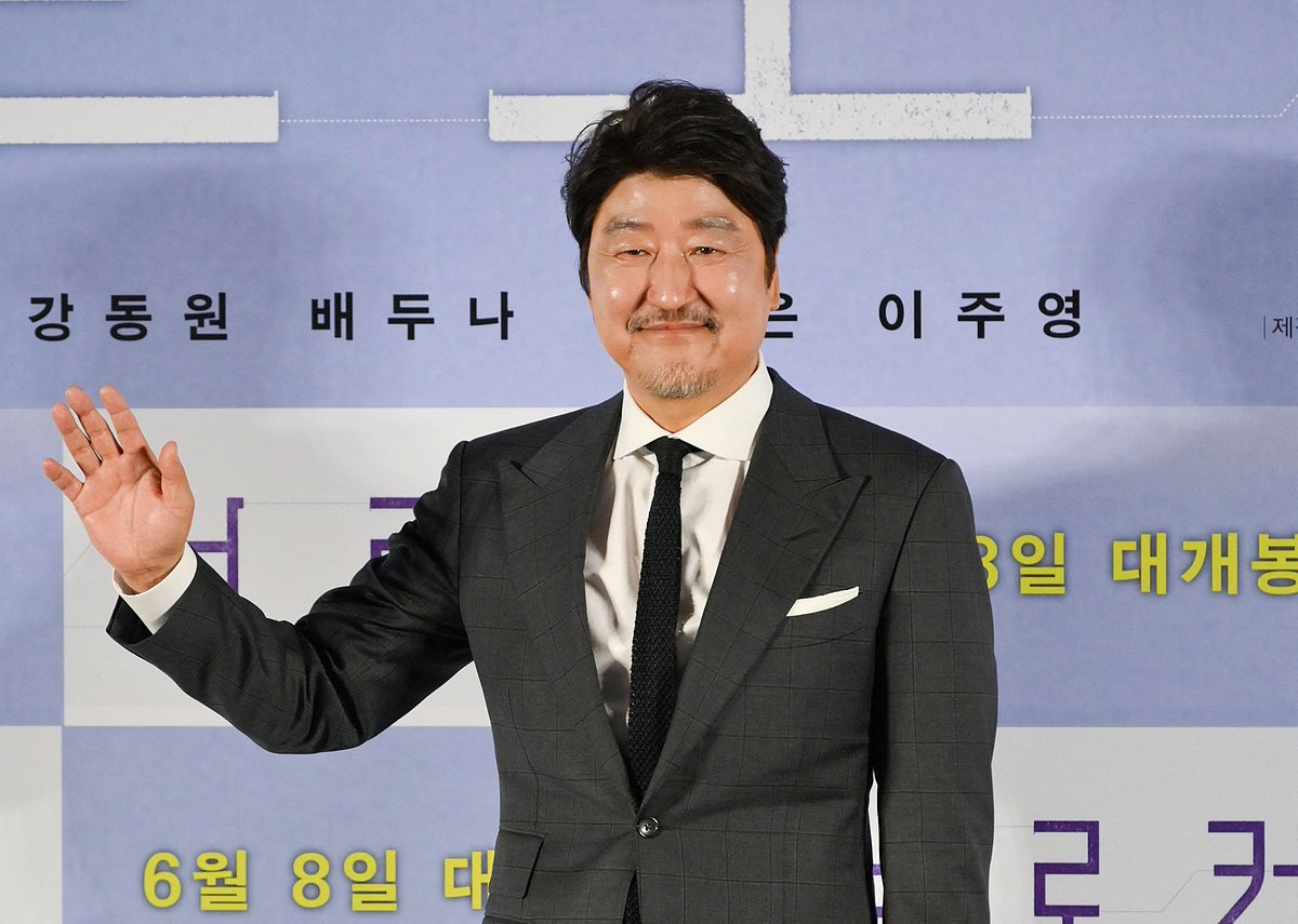 This picture taken on 10 May, 2022 shows South Korean actor Song Kang-ho posing for photos during a press conference to promote his film "Broker" in Seoul. Acclaimed Japanese filmmaker Hirokazu Kore-eda is back in competition at this year's Cannes Film Festival, with his first South Korean film which explores the country's controversial practice of "drop boxes" for unwanted babies