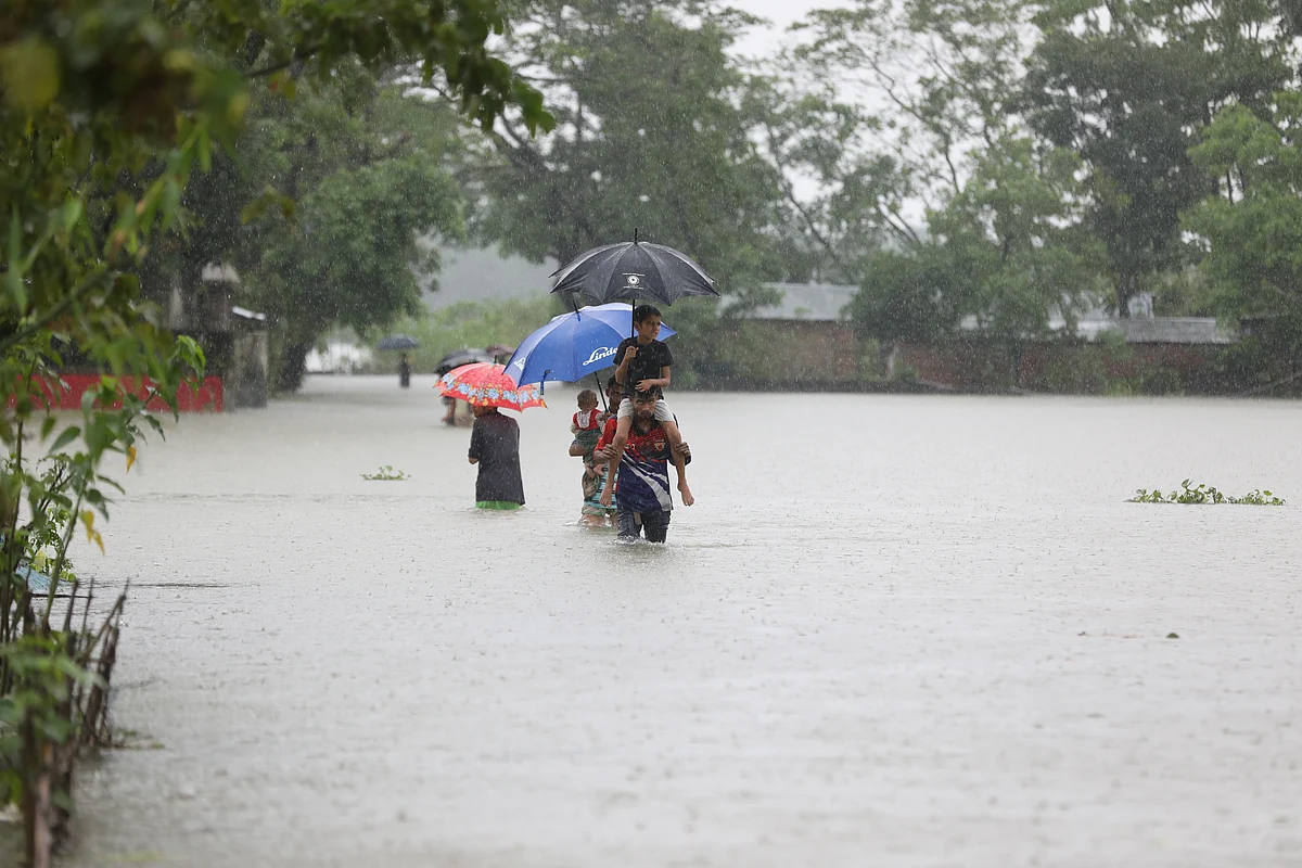 People are heading towards safer places as floods submerged their homes in Saluthikar area in Gowainghat, Sylhet.