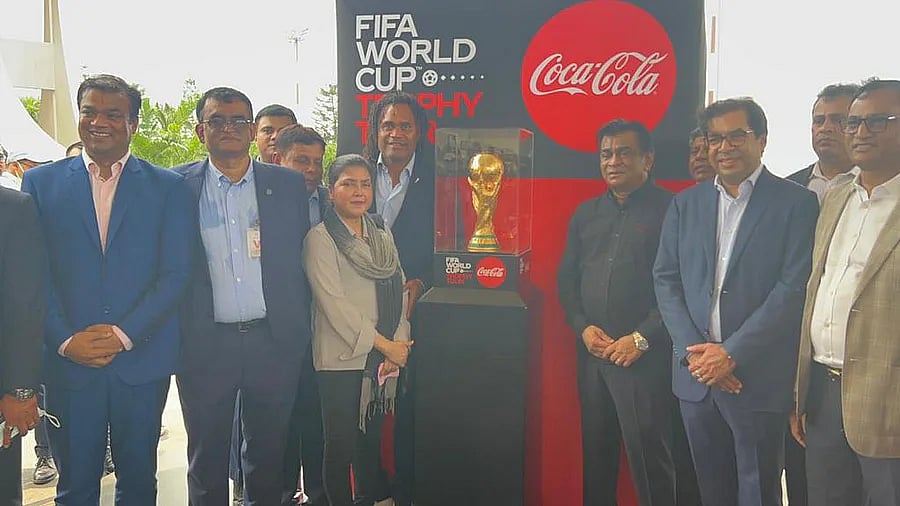 BFF president Kazi Salahuddin, World Cup winning French midfielder Christian Karembeu and other BFF officials pose with the FIFA World Cup trophy at the Hazrat Shahjalal International Airport in Dhaka on 8 June 2022.