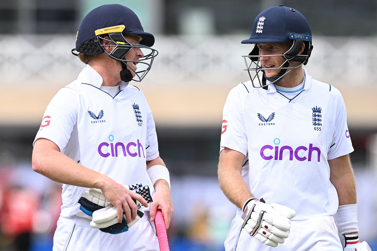 England's Ollie Pope (L) and England's Joe Root leave the pitch for the tea break on day 3 of the second Test cricket match between England and New Zealand at Trent Bridge cricket ground in Nottingham, central England, on 12 June, 2022`