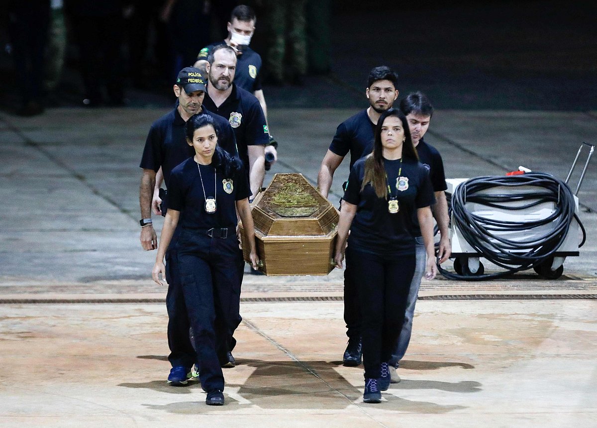 One of the coffins containing human remains found during the search for missing British journalist Dom Phillips and indigenous expert Bruno Pereira in the Amazon forest, is taken to the Federal Police hangar after being unloaded from a plane in Brasilia on 16 June, 2022.