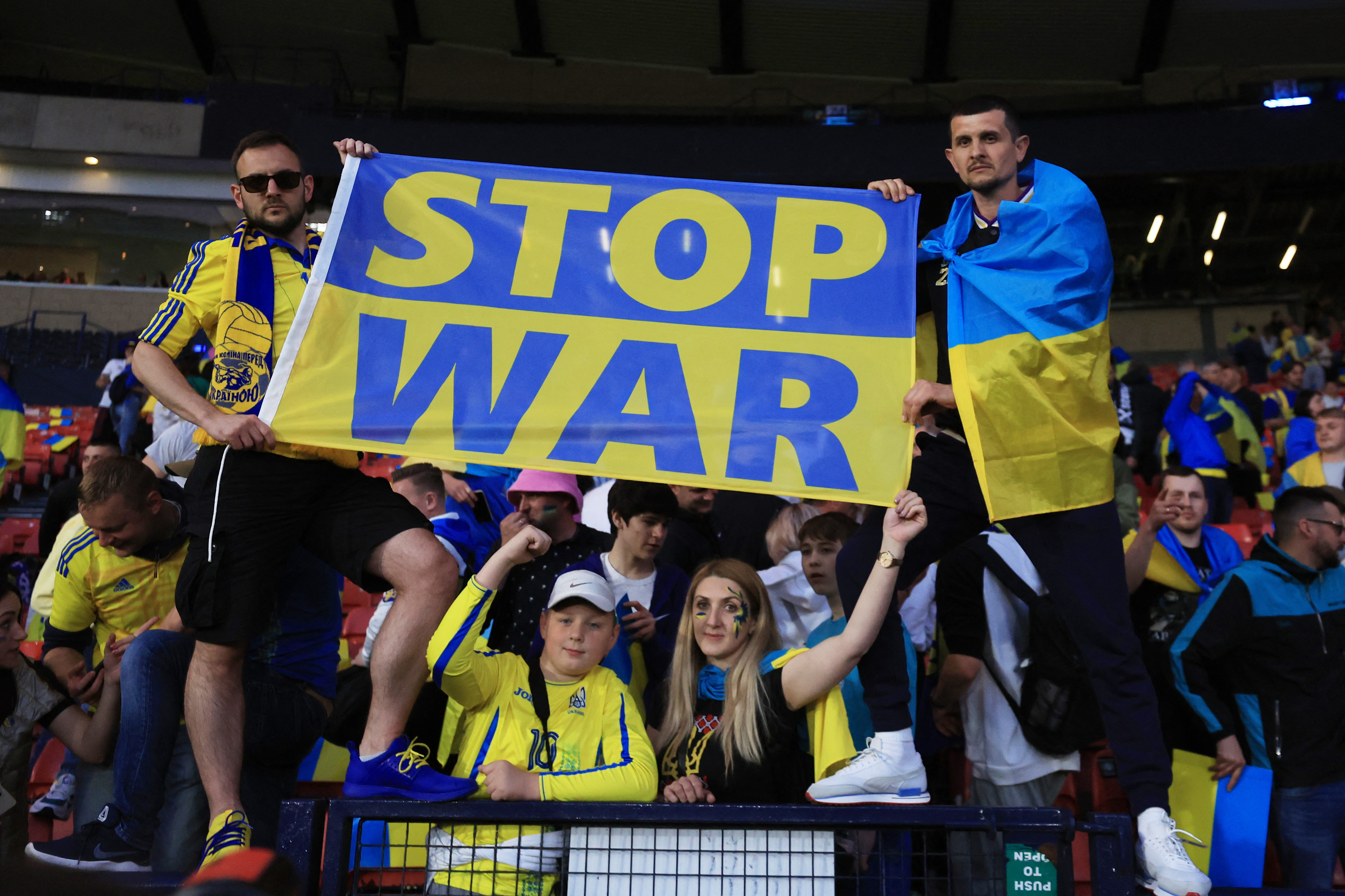 Ukraine fans celebrates their victory against Scotland at Hampden Park, Glasgow, Scotland, Britain on 1 June 2022  match and hold a flag in support of Ukraine amid Russia's invasion