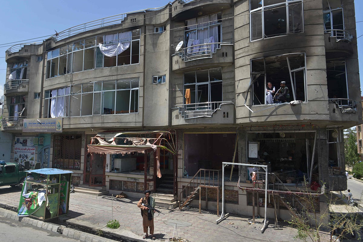A Taliban fighter stands guard in front of a Sikh temple following an attack by gunmen in Kabul on 18 June, 2022