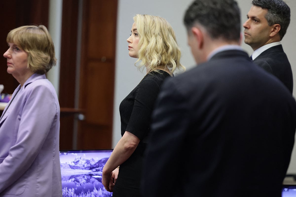 US actress Amber Heard stands after the jury said that they believe she defamed ex-husband Johnny Depp while announcing split verdicts in favor of both her ex-husband Johnny Depp and Heard on their claim and counter-claim in the Depp v. Heard civil defamation trial at the Fairfax County Circuit Courthouse in Fairfax, Virginia, 1
June 2022