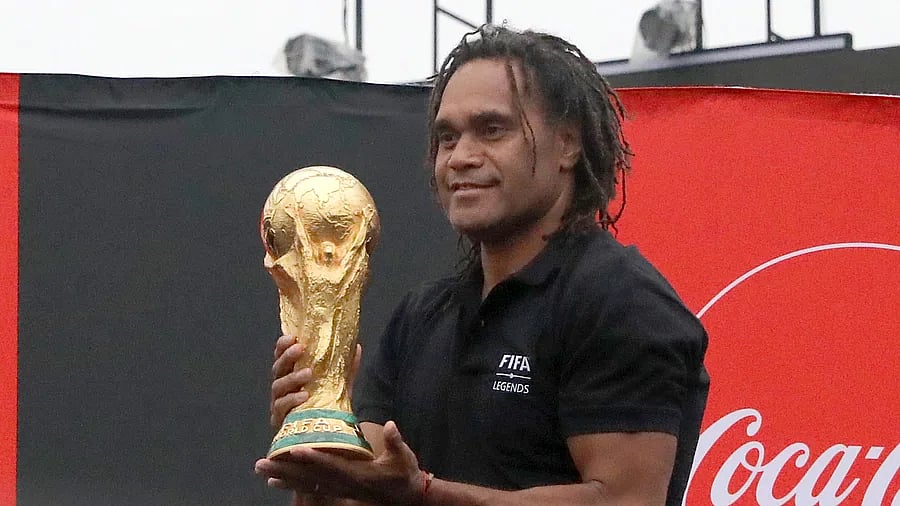 Christian Karembeu holding the FIFA World Cup trophy in Dhaka