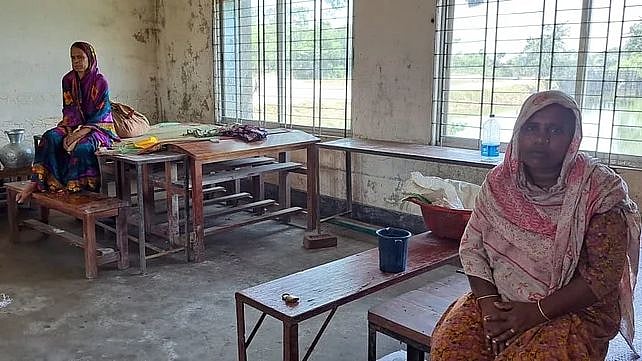 Two women at Companiganj Thana Sadar Govt Model High School flood shelter centre on the Eid day