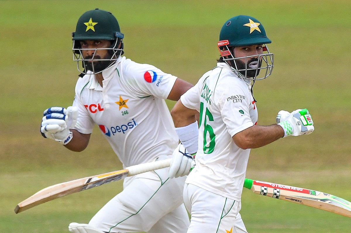 Pakistan’s Abdullah Shafique (L) and Mohammad Rizwan run between wickets during the final day of play of the first cricket Test match between Sri Lanka and Pakistan at the Galle International Cricket Stadium in Galle on 20 July, 2022
