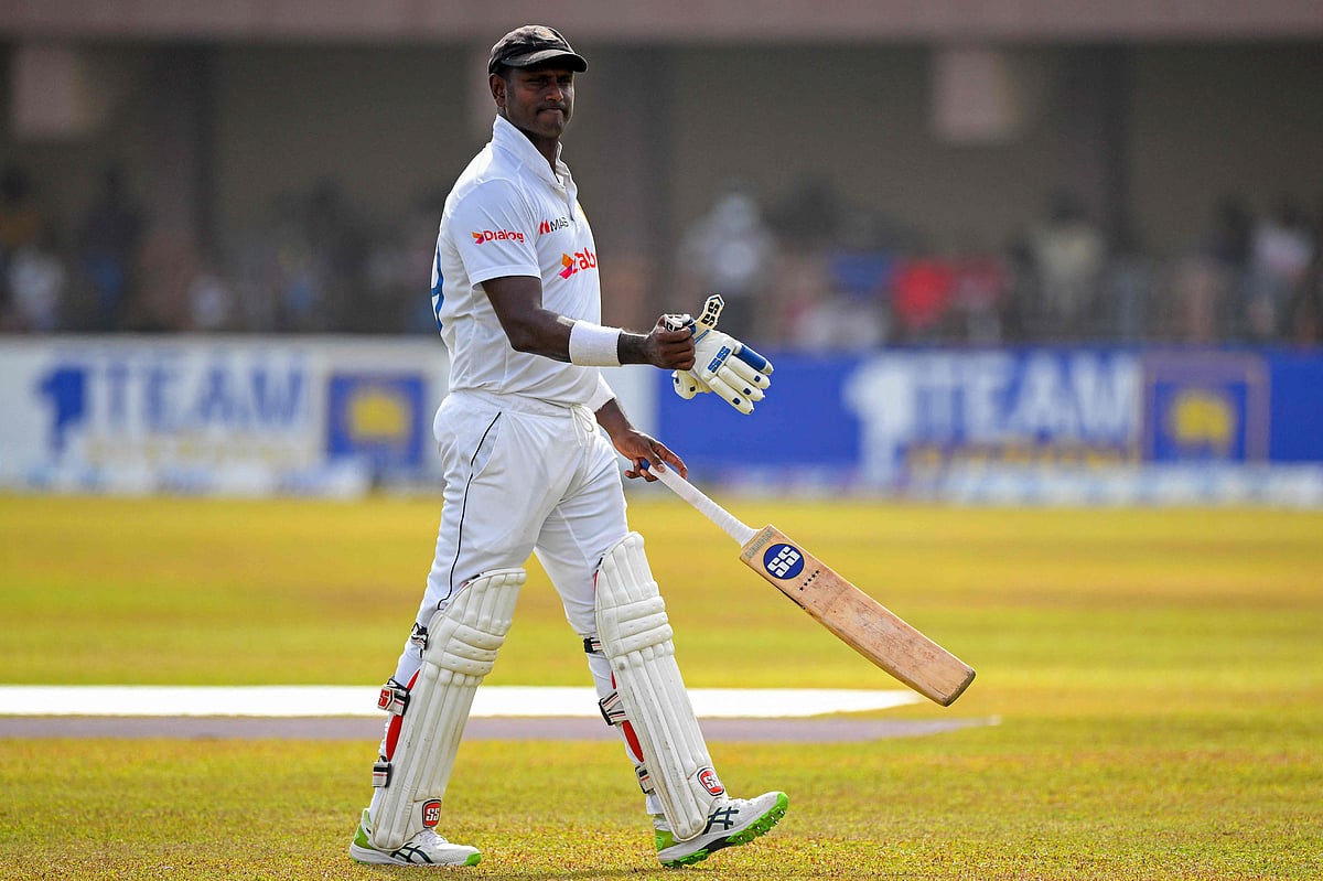 Sri Lanka's Angelo Mathews walks back to the pavilion after a dismissal