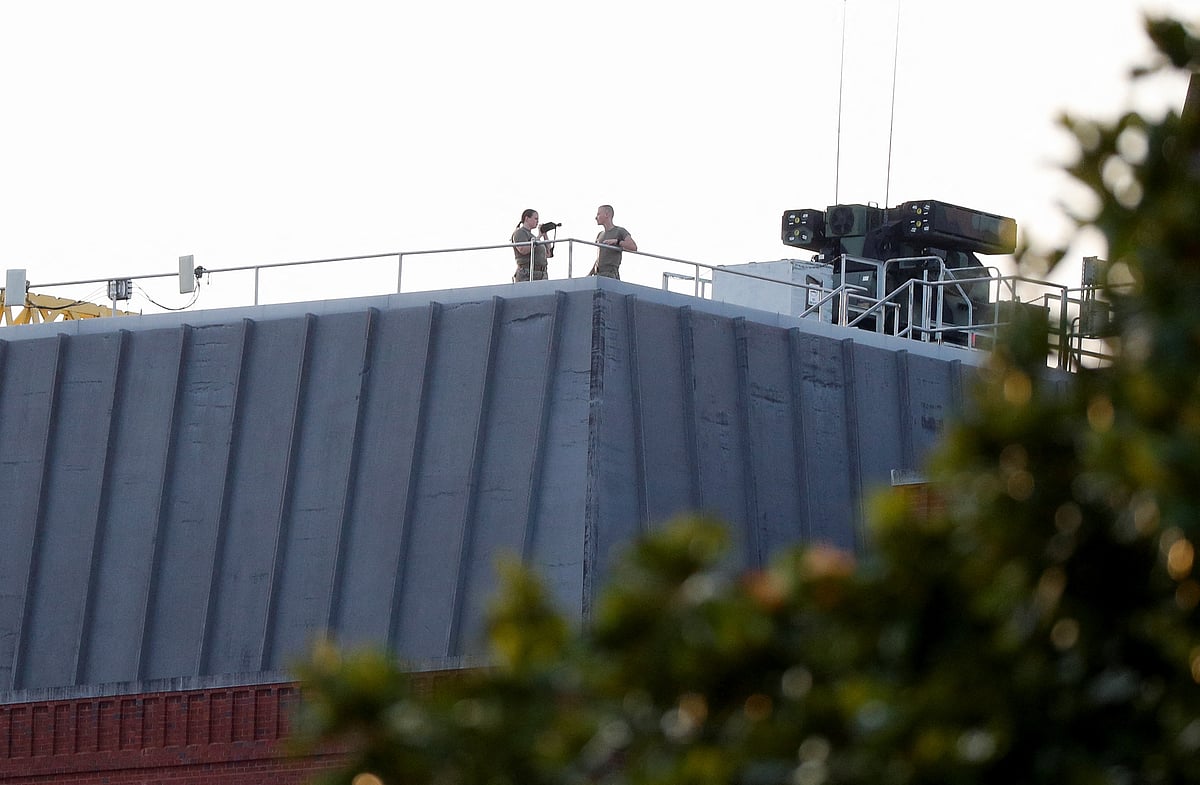 Security personnel watch beside a defensive Surface To Air missile system above the New Eisenhower executive office building near the White House, during an Independence Day celebration at the White House in Washington, US, on 4 July, 2022