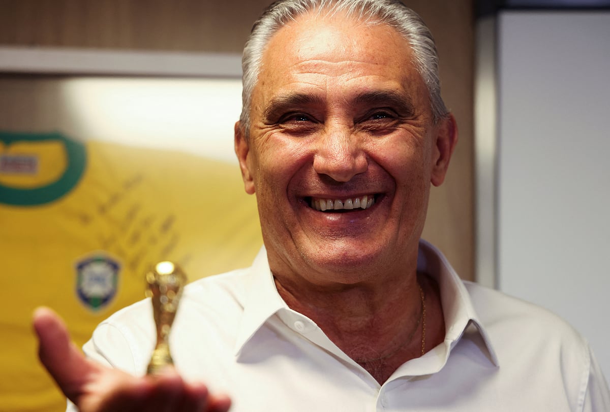 Brazilian national football team head coach Tite poses with a small replica of World Cup trophy after attending an interview with Reuters in Rio de Janeiro, Brazil on 21 July, 2022