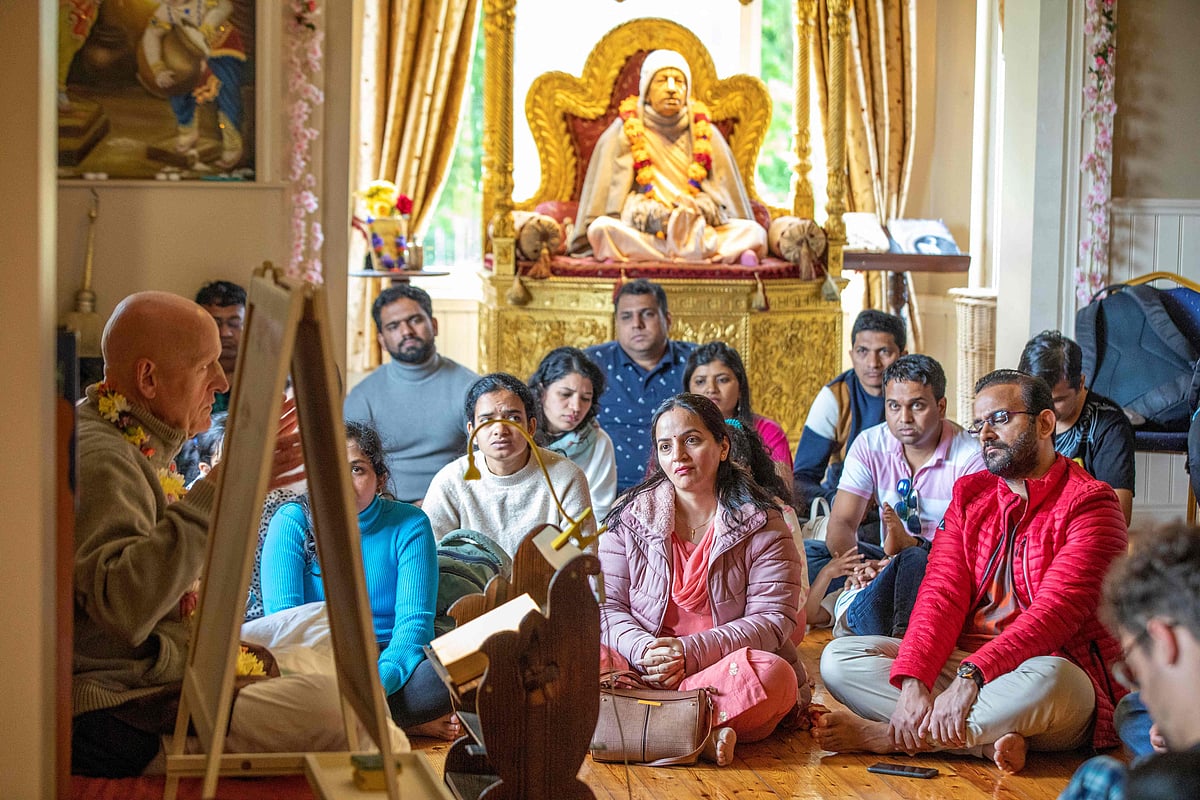 Followers of Hare Krishna listen to a lecture after prayer, on the island of Inish Rath on Lough Erne, near Enniskillen, western Northern Ireland, on 26 June, 2022, during a weekly gathering in an old Victorian hunting lodge used as a temple by Hare Krishna movement
