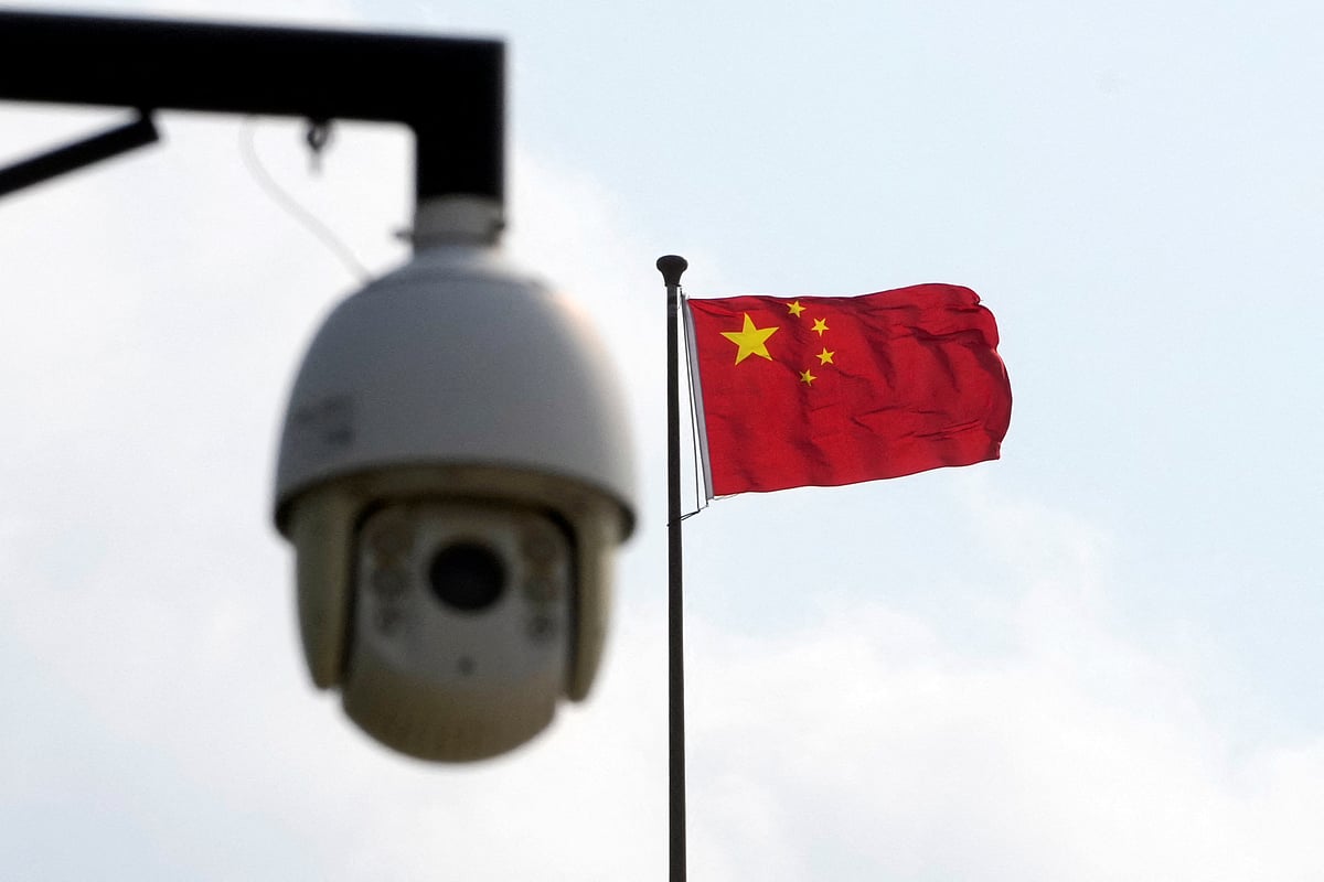 A surveillance camera is seen near a Chinese flag in Shanghai, China on 2 August, 2022.